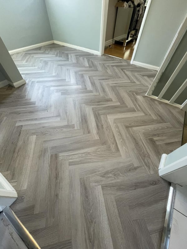 Grey herringbone LVT hallway